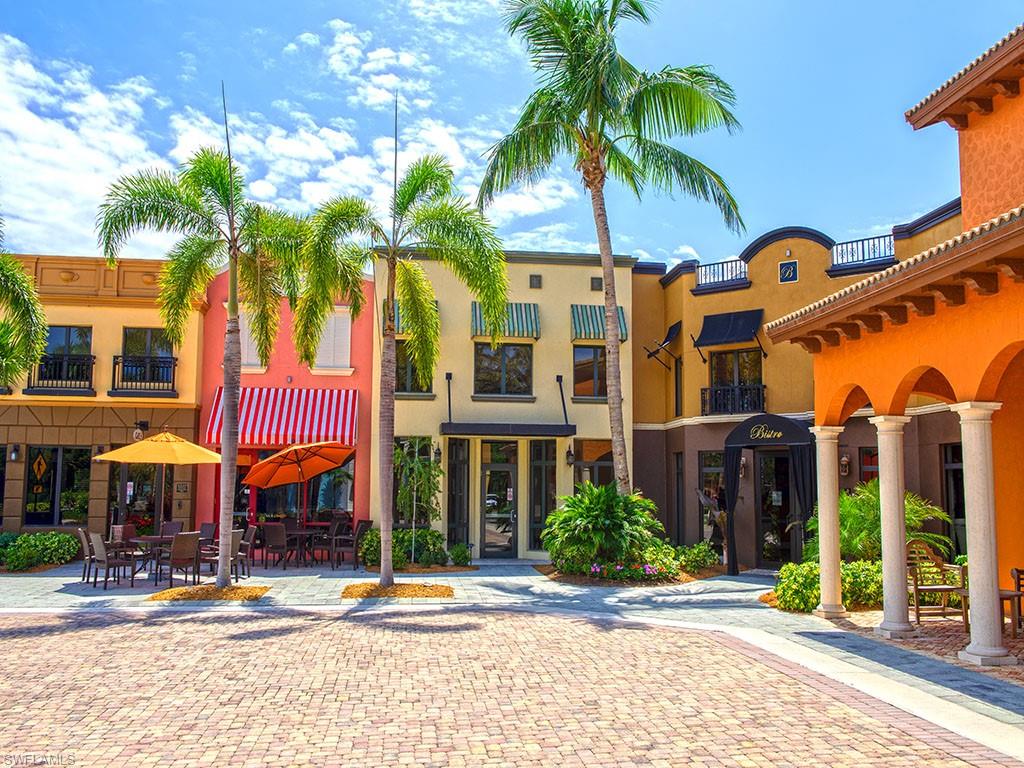 9114 Capistrano Street South, Unit 8501 Naples, FL 34113 - Photo 17 of 26 a front view of multi story residential apartment building with yard and outdoor seating