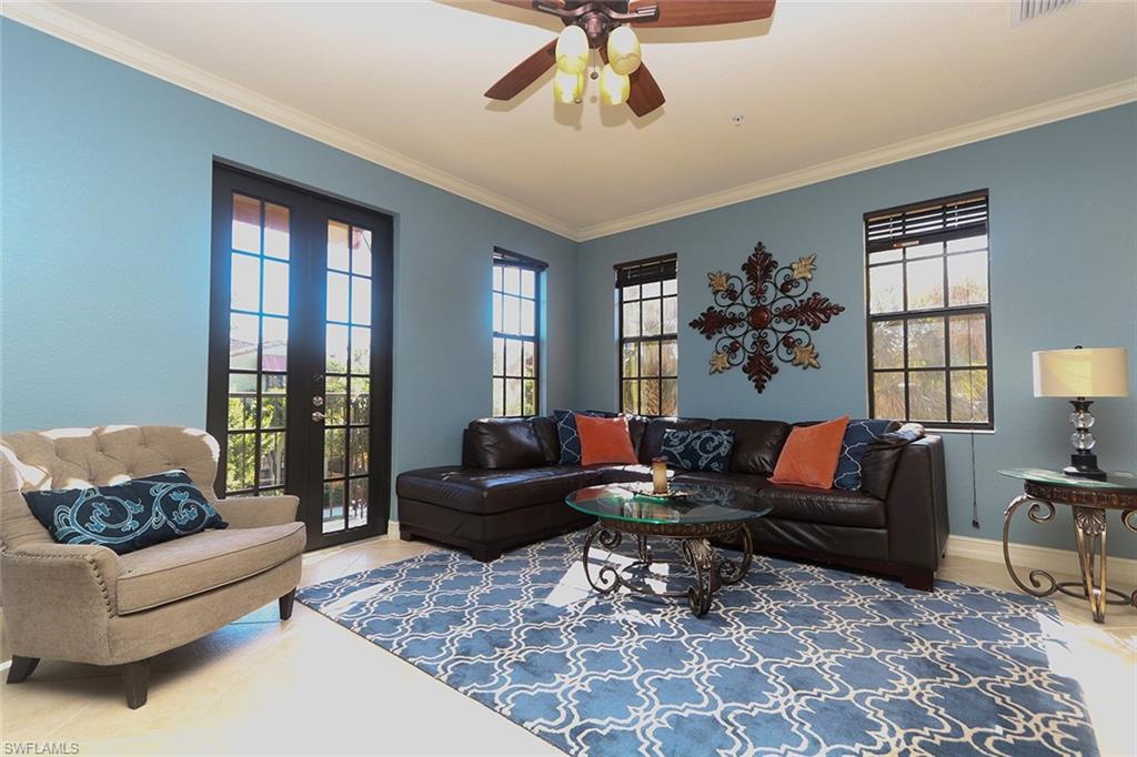 9114 Capistrano Street South, Unit 8501 Naples, FL 34113 - Photo 2 of 26 a living room with furniture rug and window