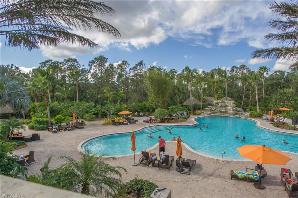 9114 Capistrano Street South, Unit 8501 Naples, FL 34113 - Photo 21 of 26 an aerial view of a swimming pool with lawn chairs and plants