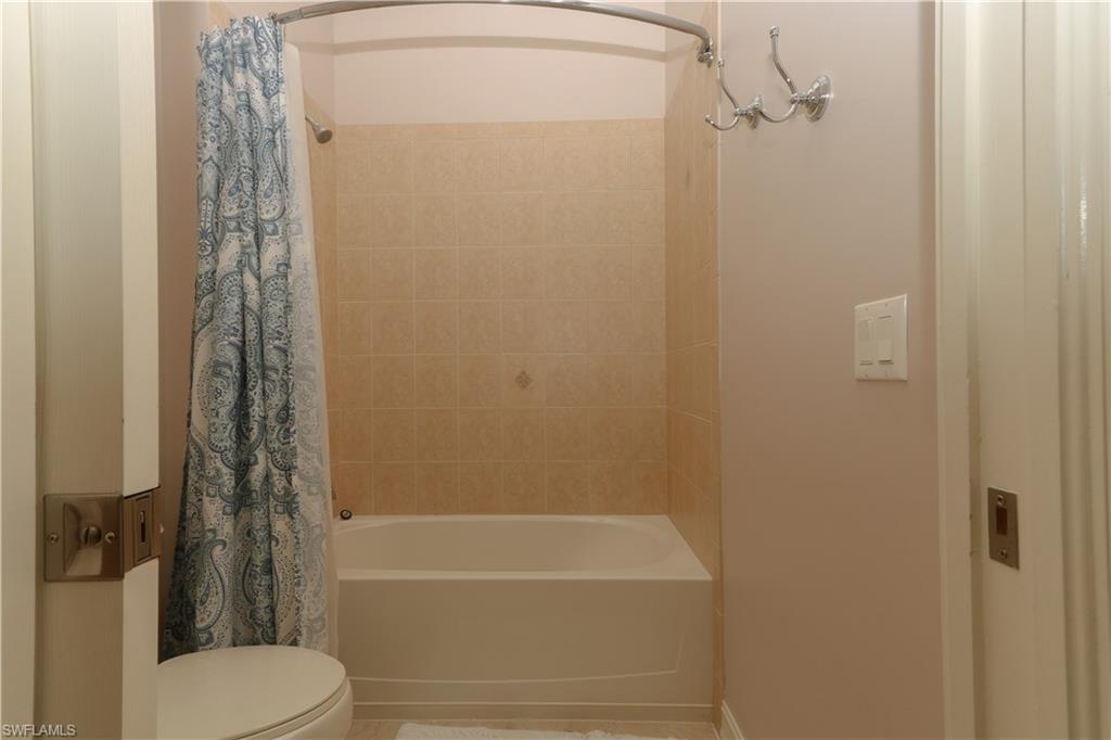 9114 Capistrano Street South, Unit 8501 Naples, FL 34113 - Photo 25 of 26 a bathroom with a shower and a toilet