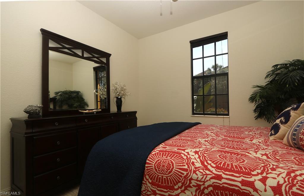 9114 Capistrano Street South, Unit 8501 Naples, FL 34113 - Photo 26 of 26 a bedroom with a bed and a window