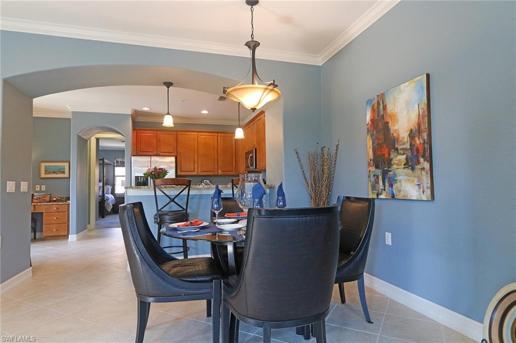9114 Capistrano Street South, Unit 8501 Naples, FL 34113 - Photo 3 of 26 a dining room with furniture a chandelier and window