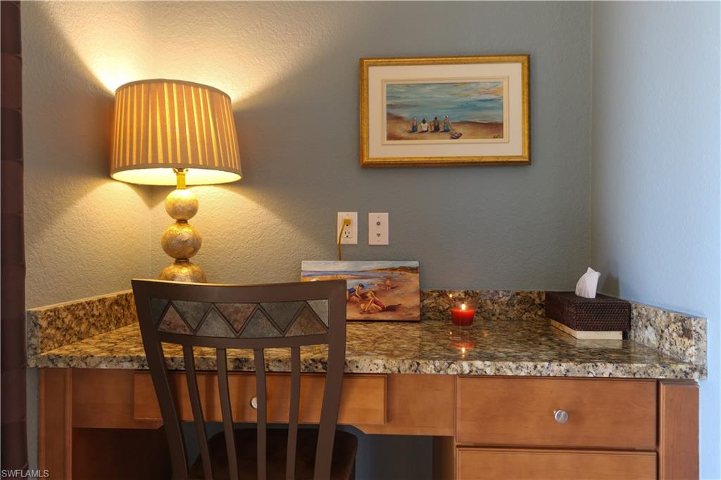 9114 Capistrano Street South, Unit 8501 Naples, FL 34113 - Photo 5 of 26 a bedroom with a bed and dresser