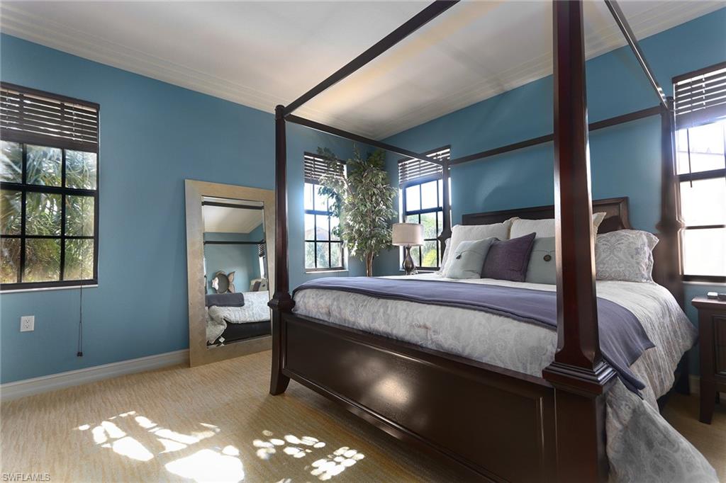 9114 Capistrano Street South, Unit 8501 Naples, FL 34113 - Photo 6 of 26 a bed sitting in a room next to a window