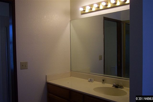 1515 Clough Road Reno, NV 89509 - Photo 11 of 13 a bathroom with a sink and a mirror