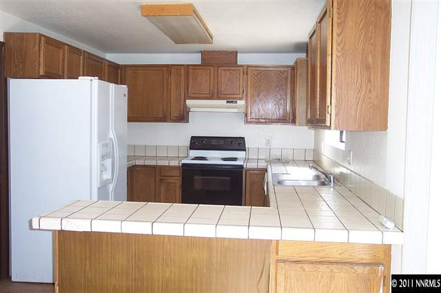 1515 Clough Road Reno, NV 89509 - Photo 4 of 13 a kitchen with a stove a refrigerator and a sink