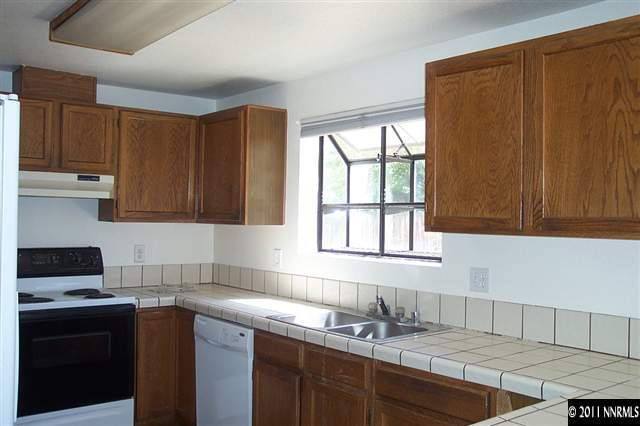 1515 Clough Road Reno, NV 89509 - Photo 5 of 13 a kitchen with granite countertop cabinets sink and window