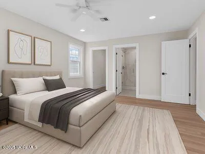 a spacious bedroom with a bed and a wooden floor