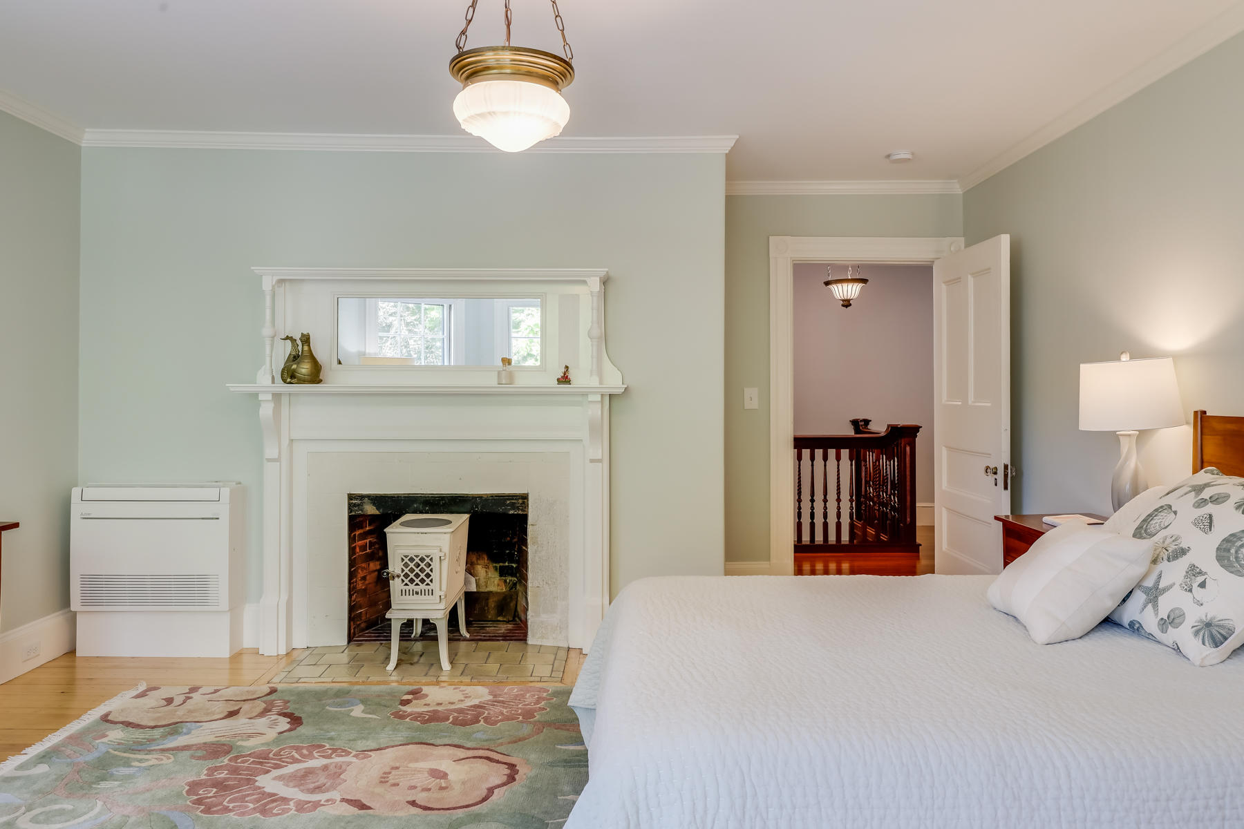 39 Juniper Point Road Woods Hole, MA 02543 - Photo 34 of 53 a bedroom with a bed and a fireplace
