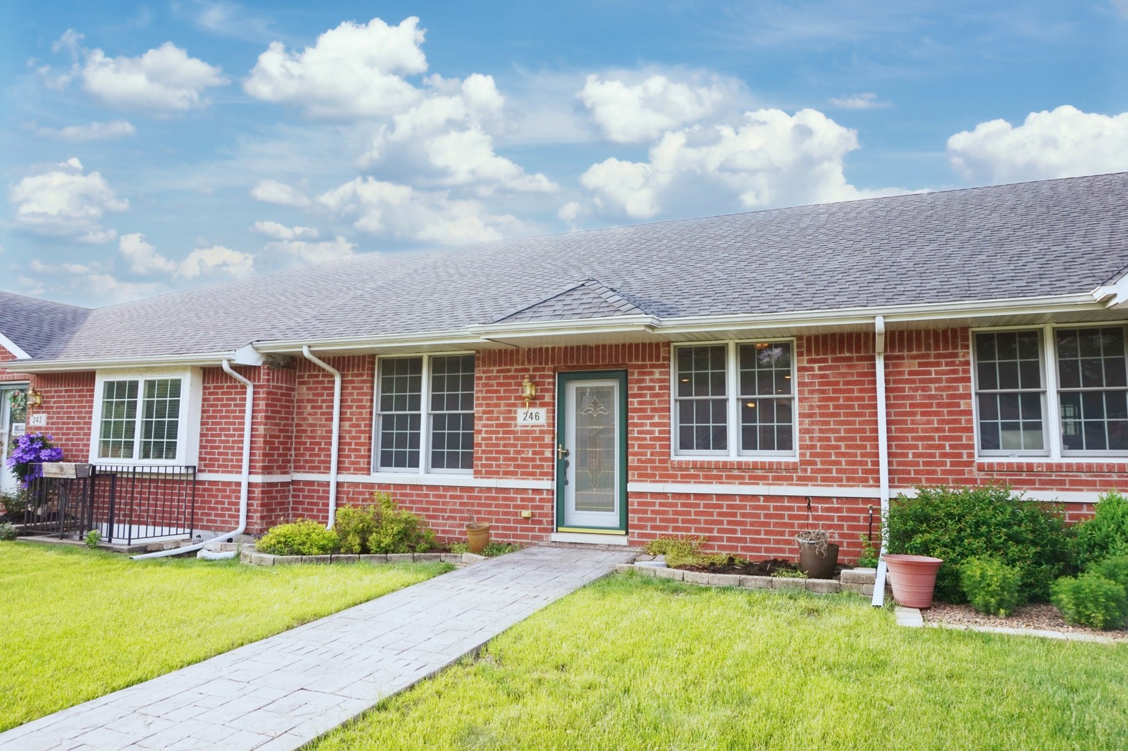 a front view of a house with a yard and porch
