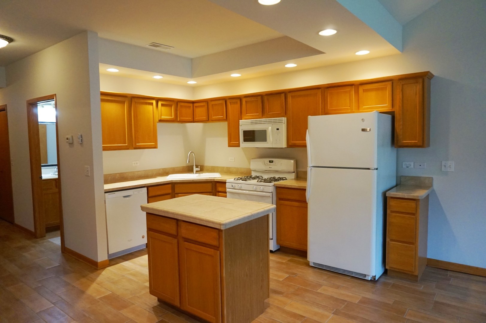 Undisclosed Address Wilmington, IL 60481 - Photo 7 of 18 a kitchen with a refrigerator a stove and wooden floor