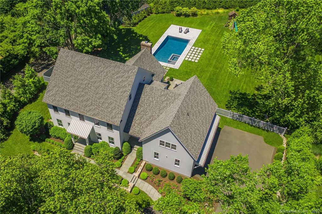 an aerial view of a house with swimming pool and garden space