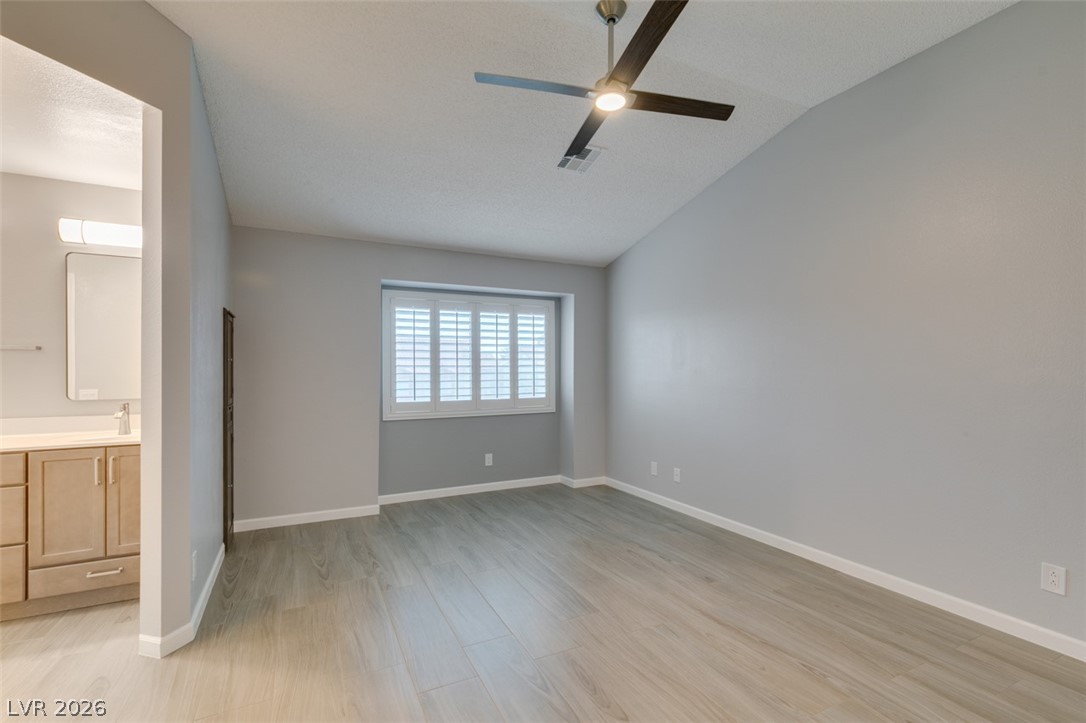 540 Sutters Mill Road Henderson, NV 89014 - Photo 40 of 46 This spacious bedroom features ample natural light and a modern ceiling fan, creating a comfortable living space.
