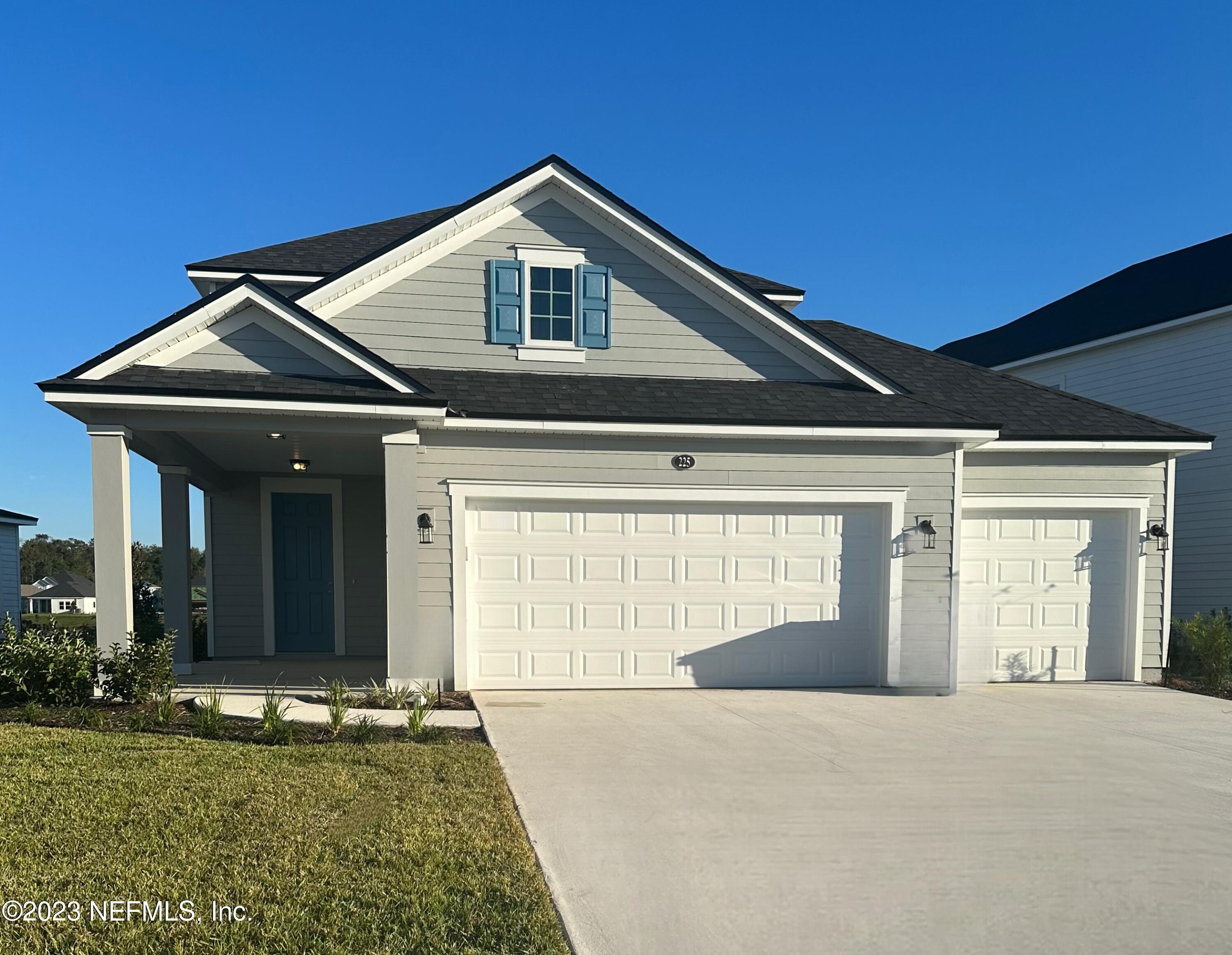 225 Stargaze Lane St. Augustine, FL 32095 - Photo 1 of 13 a front view of a house with a yard