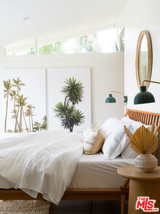 29107 Cliffside Drive Malibu, CA 90265 - Photo 11 of 22 a bedroom with a bed and a potted plant
