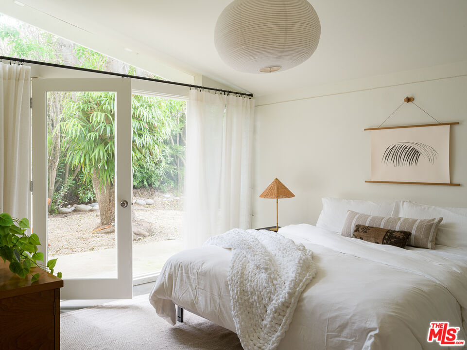 29107 Cliffside Drive Malibu, CA 90265 - Photo 13 of 22 a bedroom with a bed and a large window