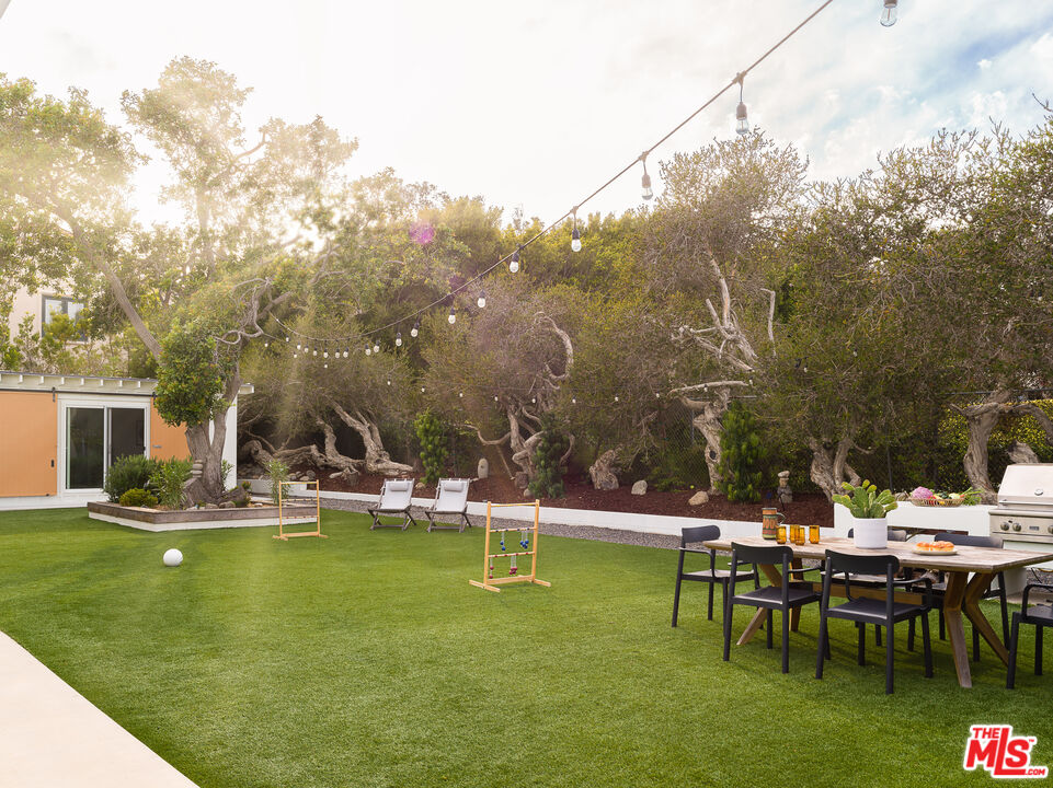 29107 Cliffside Drive Malibu, CA 90265 - Photo 19 of 22 a view of a swimming pool with lawn chairs and plants