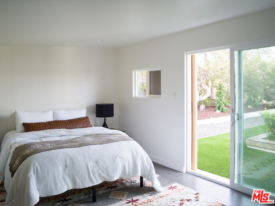 29107 Cliffside Drive Malibu, CA 90265 - Photo 20 of 22 a bedroom with a bed and a window