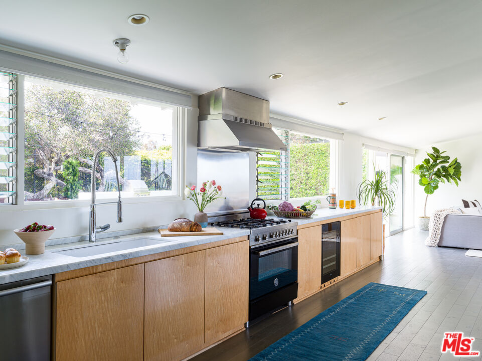 29107 Cliffside Drive Malibu, CA 90265 - Photo 6 of 22 a kitchen with a sink stove and wooden floor