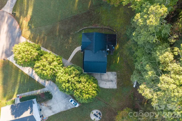 an aerial view of a residential houses with yard