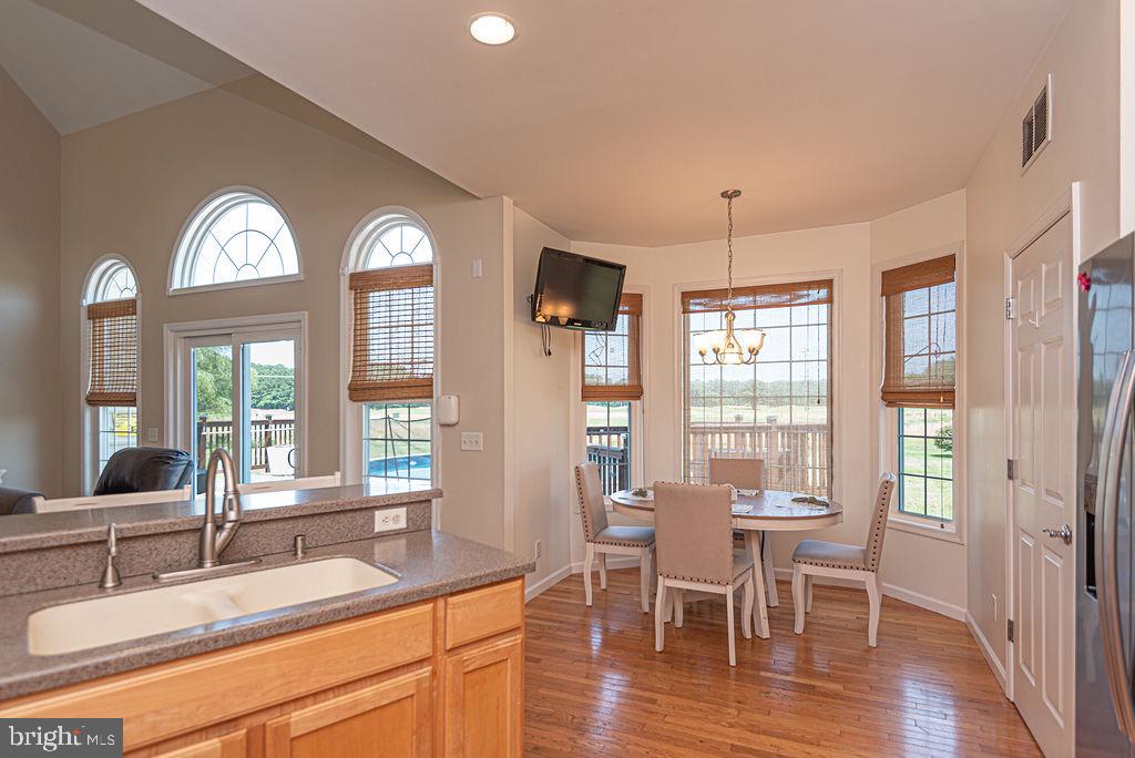 10671 Cathell Road Berlin, MD 21811 - Photo 13 of 63 a view of a dining room with furniture window and wooden floor
