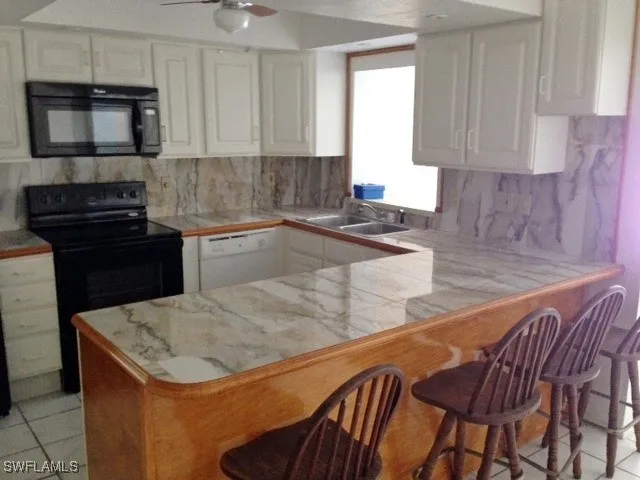 a kitchen with a stove a sink and a microwave