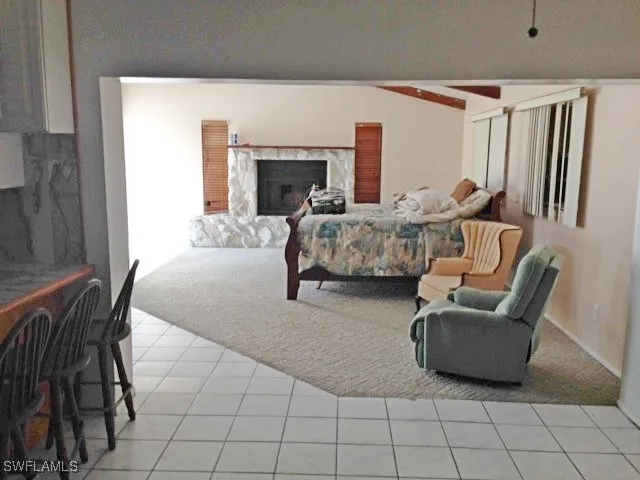 a bedroom with furniture and a fireplace