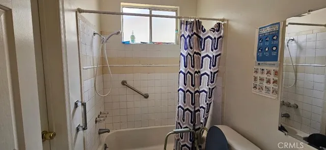 a bathroom with a bathtub and shower