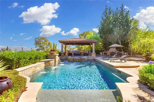 a dining room with furniture a chandelier and wooden floor