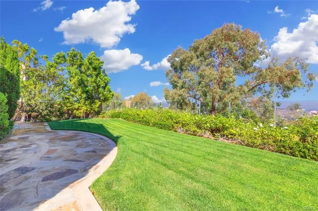 a living room with stainless steel appliances granite countertop furniture wooden floor and a kitchen view