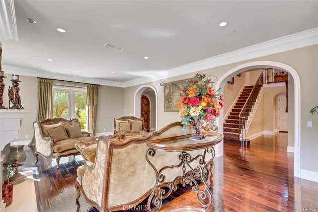 a view of a living room with furniture and a book shelf