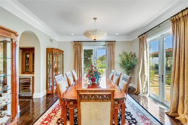 a view of a hallway with wooden floor and windows