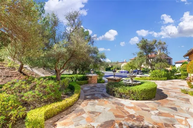a view of a patio with a table and chairs under an umbrella with a fire pit