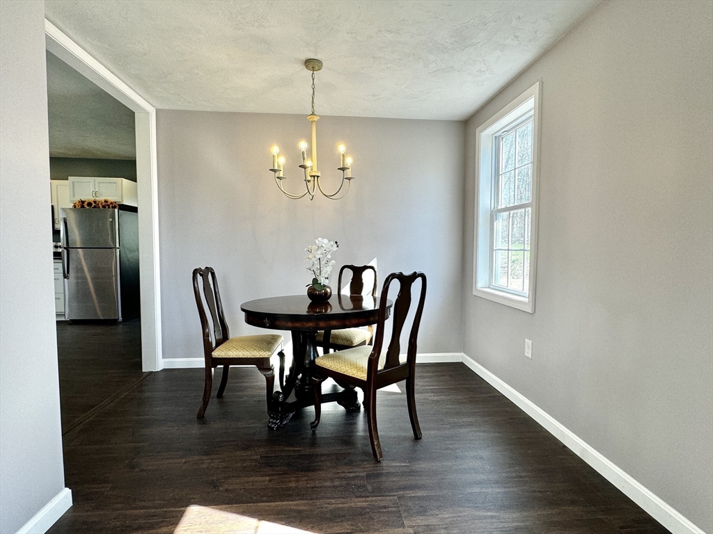 11 Main Street Brookfield, MA 01506 - Photo 11 of 29 a dining room with furniture a chandelier and wooden floor