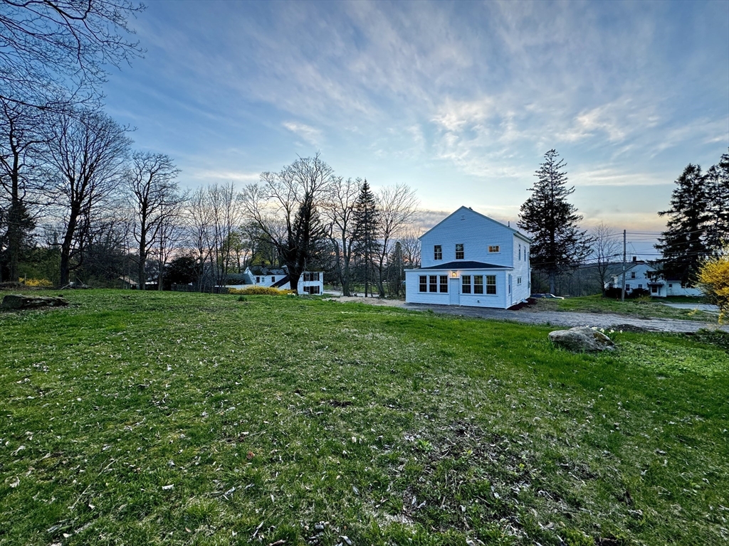 11 Main Street Brookfield, MA 01506 - Photo 2 of 29 a view of a big house with a big yard and large trees