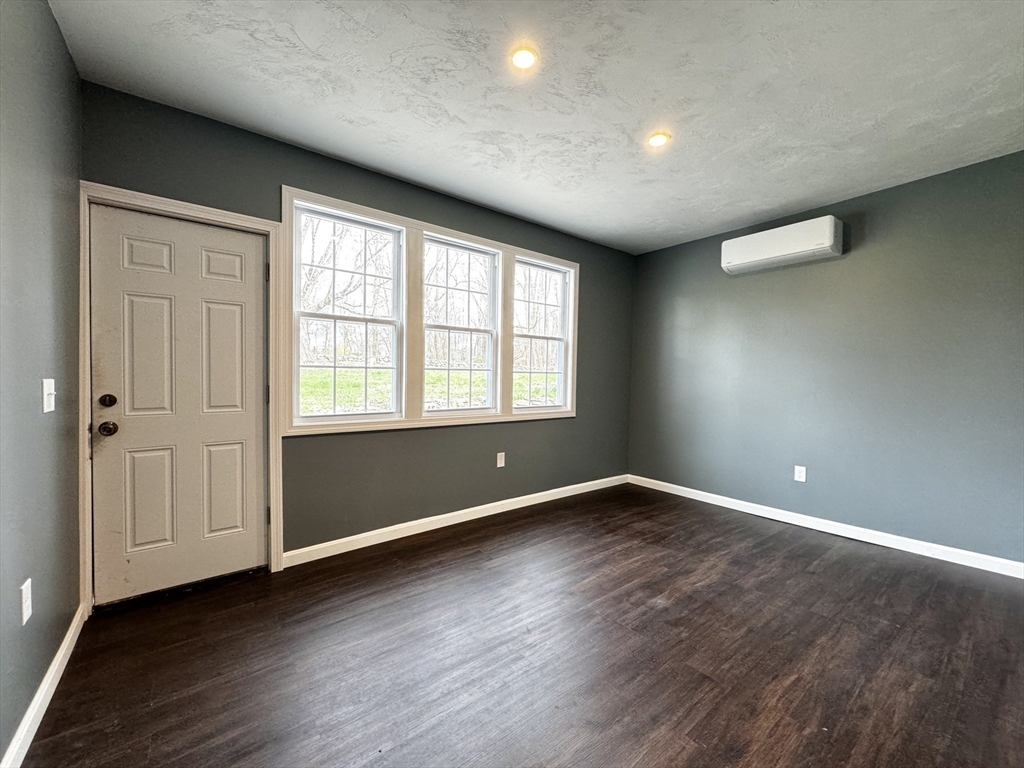 11 Main Street Brookfield, MA 01506 - Photo 24 of 29 an empty room with wooden floor and windows