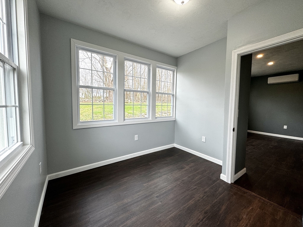 11 Main Street Brookfield, MA 01506 - Photo 25 of 29 an empty room with wooden floor and windows