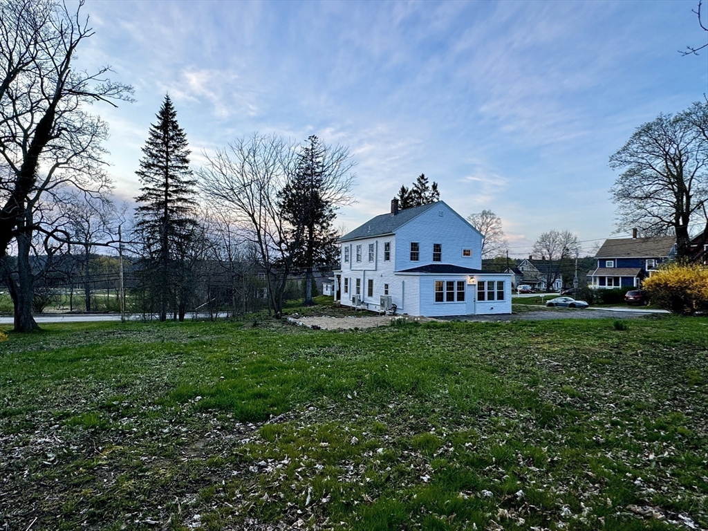 11 Main Street Brookfield, MA 01506 - Photo 27 of 29 a house with green field in front of it