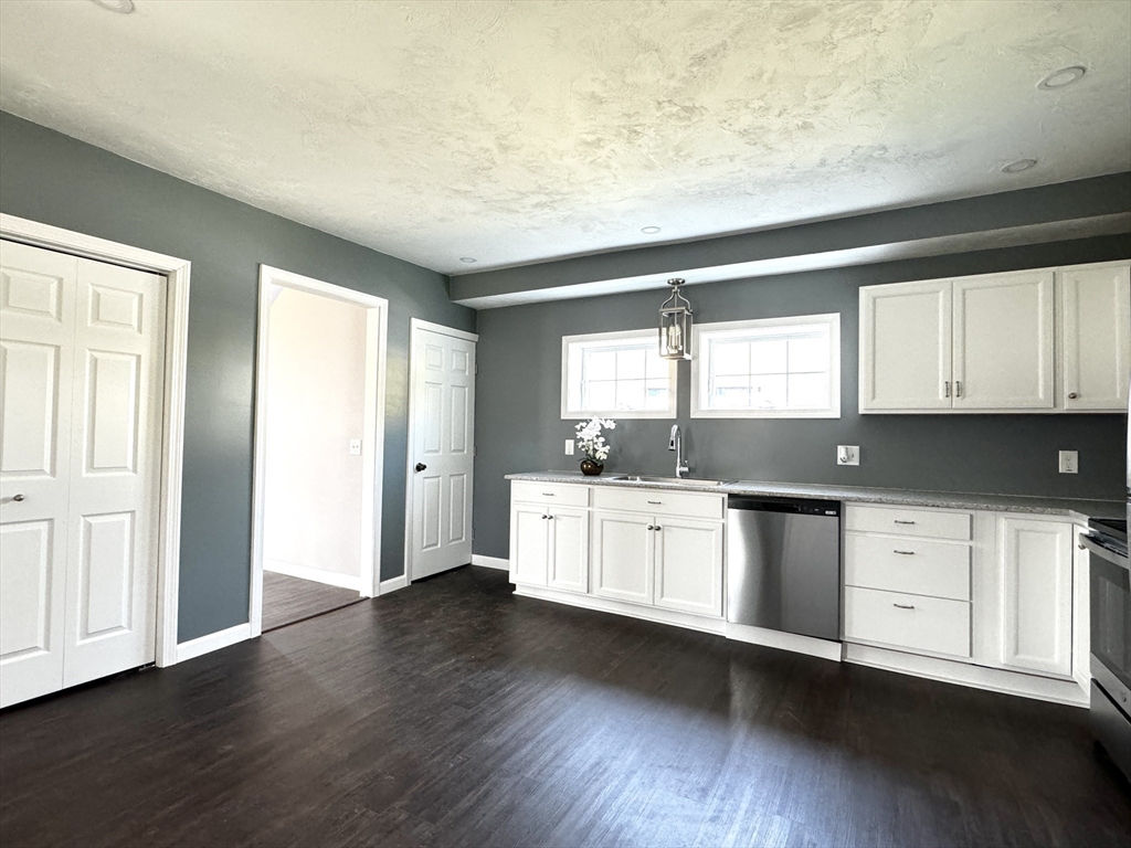 11 Main Street Brookfield, MA 01506 - Photo 6 of 29 a kitchen with granite countertop white cabinets and wooden floor
