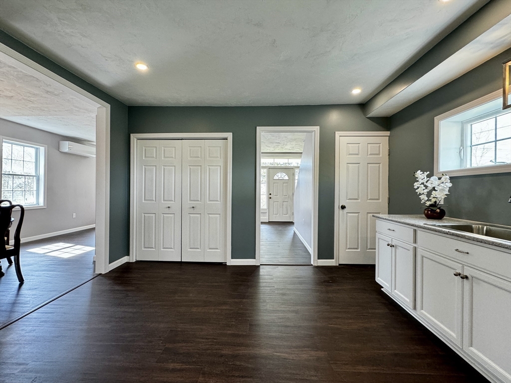 11 Main Street Brookfield, MA 01506 - Photo 7 of 29 a view of a hallway with wooden floor and a living room