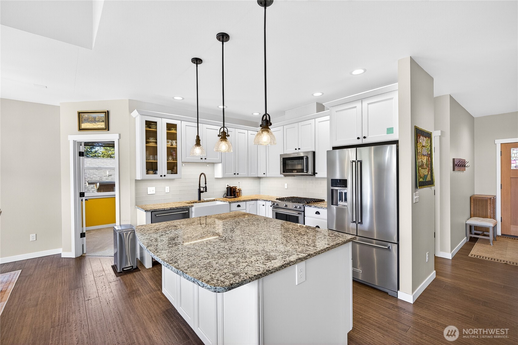 1268 Curtis Way Freeland, WA 98249 - Photo 12 of 40 a kitchen with stainless steel appliances granite countertop a sink refrigerator and microwave