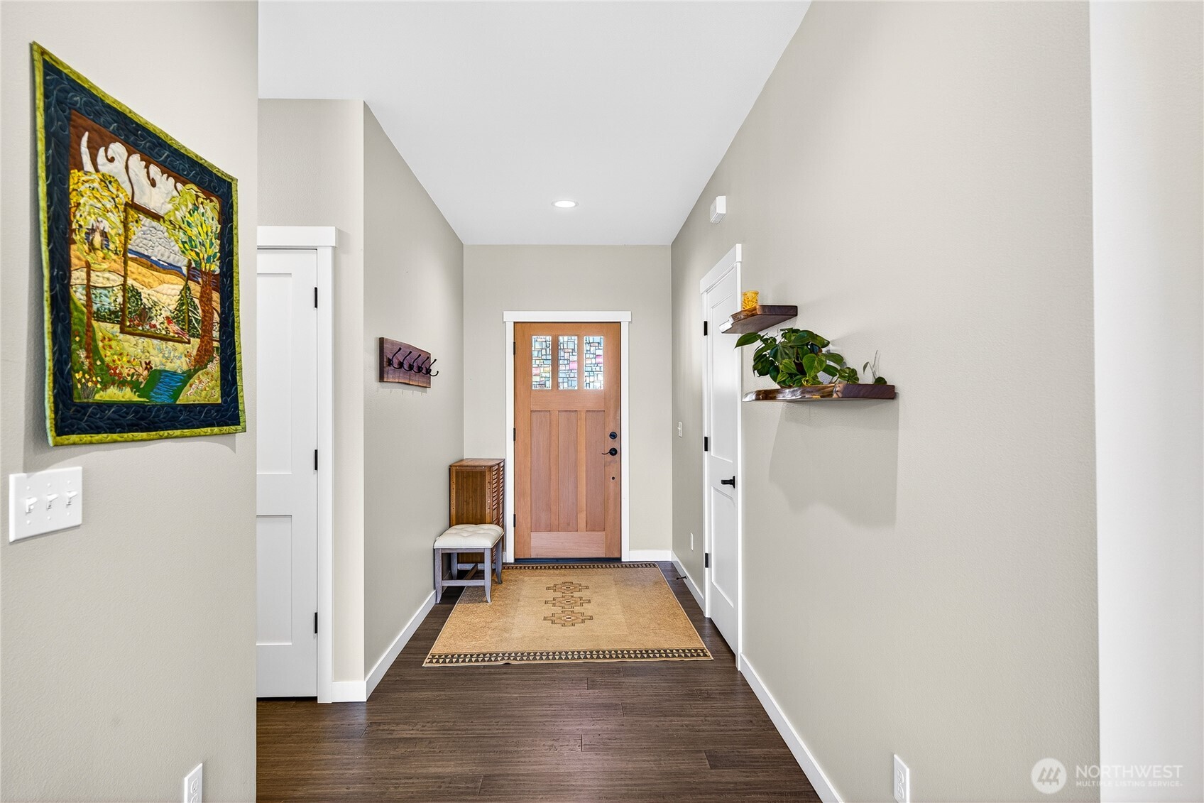 1268 Curtis Way Freeland, WA 98249 - Photo 16 of 40 a view of a hallway with wooden floor and windows