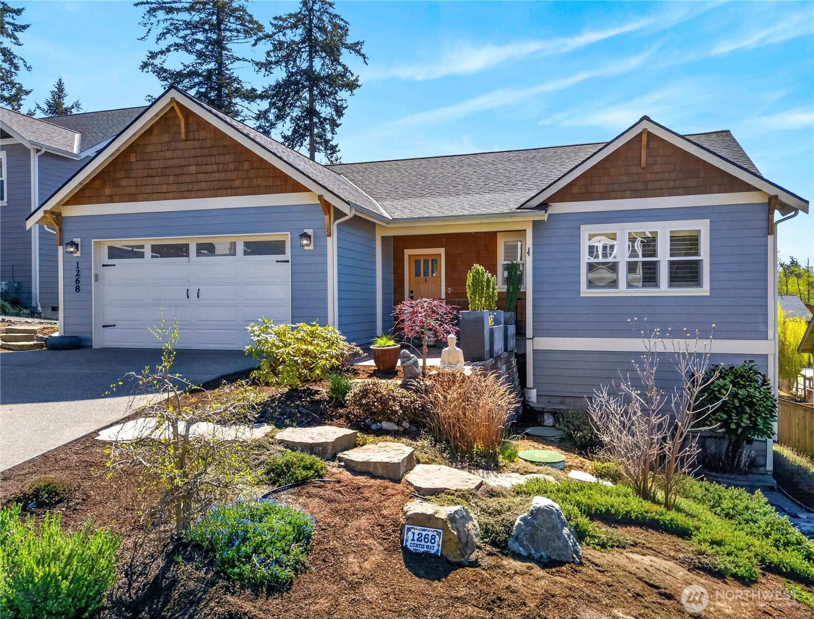 1268 Curtis Way Freeland, WA 98249 - Photo 3 of 40 a front view of a house with garden