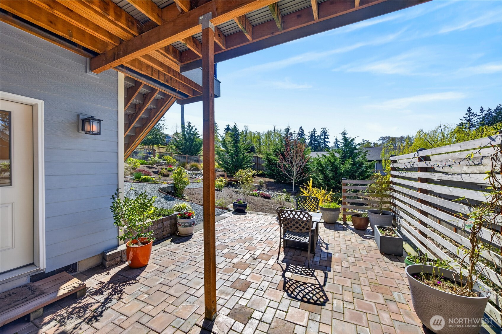 1268 Curtis Way Freeland, WA 98249 - Photo 31 of 40 a view of a patio with a table and chairs and potted plants