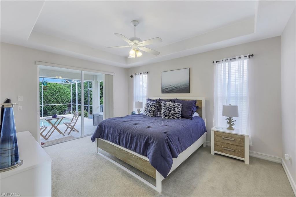 31 Tahiti Road Marco Island, FL 34145 - Photo 11 of 27 a bedroom with a bed and a chandelier