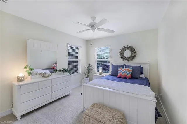 a bedroom with a bed and ceiling fan