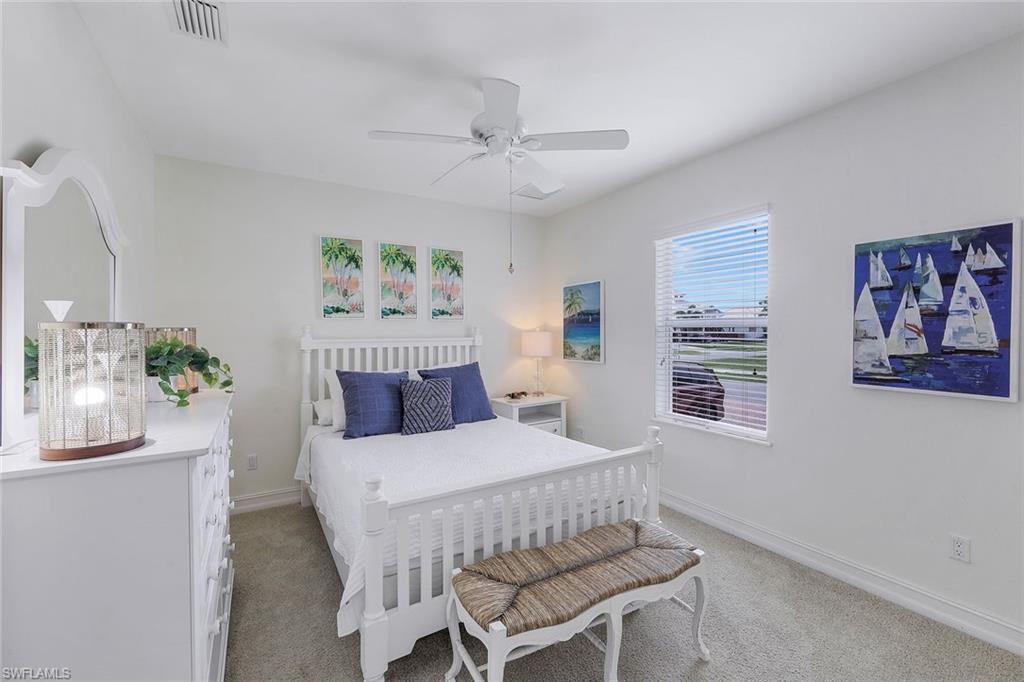 31 Tahiti Road Marco Island, FL 34145 - Photo 16 of 27 a bedroom with a bed painting on wall and a large window