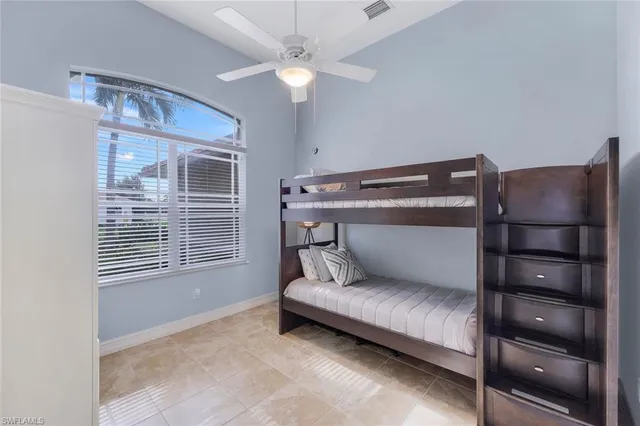a living room with a couch and a ceiling fan