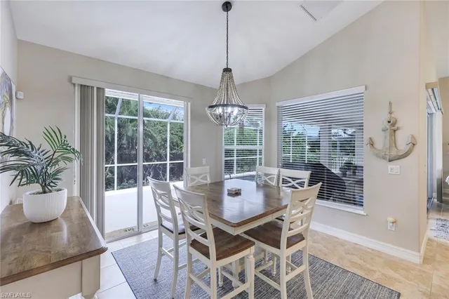 a dining room with furniture wooden floor and a chandelier