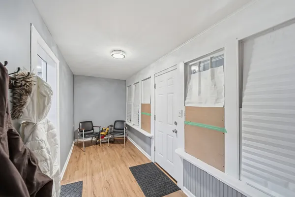 a view of a room with furniture and wooden floor